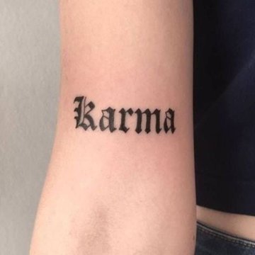 tatuaż karma na ramieniu